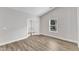 Bright living space features neutral walls, wood flooring, and a glass door at 203 Jetson Creek Way, Youngsville, NC 27596