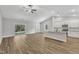 Open-concept living space boasts wood floors, white trim, and natural light at 203 Jetson Creek Way, Youngsville, NC 27596