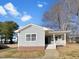 Charming single-story home with blue siding, red brick accents, and a cozy front porch at 265 Freeman Pines Pl, Fuquay Varina, NC 27526