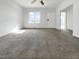 Bright living room featuring a large window allowing for ample natural light at 265 Freeman Pines Pl, Fuquay Varina, NC 27526