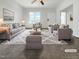 Bright living room featuring neutral tones, with a large window allowing for ample natural light at 265 Freeman Pines Pl, Fuquay Varina, NC 27526