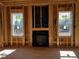 Framed living room fireplace with two windows at 28 Golden View Pl, Zebulon, NC 27597