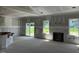 Bright living room featuring a modern fireplace, and sliding glass doors to the backyard at 28 Golden View Pl, Zebulon, NC 27597