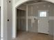Bright living room featuring an arched doorway, unfinished drywall, and white trim at 28 Golden View Pl, Zebulon, NC 27597