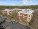 Aerial view of modern apartment buildings with balconies, parking lots, and surrounding greenery at 300 Finsbury St # 313, Durham, NC 27703