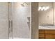 Bathroom featuring a shower with tiled walls and granite countertops at 300 Finsbury St # 313, Durham, NC 27703