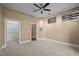 Bedroom showing a walk in closet, neutral walls, and ceiling fan at 300 Finsbury St # 313, Durham, NC 27703