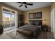 Cozy bedroom featuring modern decor, a ceiling fan, and private balcony access for outdoor enjoyment at 300 Finsbury St # 313, Durham, NC 27703
