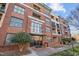 Beautiful brick building with large glass windows and multiple balconies, offering an inviting facade at 300 Finsbury St # 313, Durham, NC 27703
