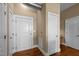 Hallway featuring hardwood floors, several doors, and an industrial-style exposed ventilation system at 300 Finsbury St # 313, Durham, NC 27703