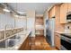 Well-equipped kitchen with stainless appliances, granite countertops, and a built-in desk area for added convenience at 300 Finsbury St # 313, Durham, NC 27703