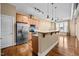 Modern kitchen features stainless steel appliances, granite countertops, and an island with pendant lighting at 300 Finsbury St # 313, Durham, NC 27703