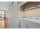 Convenient laundry area featuring a side-by-side washer and dryer, with storage shelves above for organization at 300 Finsbury St # 313, Durham, NC 27703