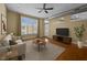 Relaxing living room with a ceiling fan, large window, door to patio, and a modern decor at 300 Finsbury St # 313, Durham, NC 27703