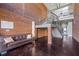 Spacious lobby with brick accent wall, modern staircase, stylish sofa, and polished concrete floors at 300 Finsbury St # 313, Durham, NC 27703