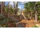 A fully fenced backyard with a wooden gate, shed, and lush landscaping at 300 Mccauley St, Chapel Hill, NC 27516