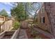 Backyard featuring gravel path, storage shed, mature trees, and manicured landscaping at 300 Mccauley St, Chapel Hill, NC 27516