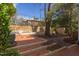Charming backyard featuring a brick patio, mature trees, garden beds, and a storage shed at 300 Mccauley St, Chapel Hill, NC 27516