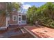 Backyard featuring a brick patio with lush landscaping and a screened porch at 300 Mccauley St, Chapel Hill, NC 27516