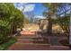 Inviting backyard patio with brick pavers, seating area, lush landscaping and a tranquil water feature at 300 Mccauley St, Chapel Hill, NC 27516