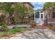 Landscaped backyard with patio area, stone steps, and access to a screened porch at 300 Mccauley St, Chapel Hill, NC 27516