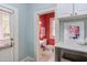 Charming powder room featuring red accent wall, a white pedestal sink, and decorative art at 300 Mccauley St, Chapel Hill, NC 27516