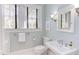 Well-lit bathroom with a vanity, toilet, and window offering natural light at 300 Mccauley St, Chapel Hill, NC 27516