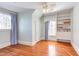 Spacious bedroom featuring hardwood floors, built-in shelving, and natural light from a large window at 300 Mccauley St, Chapel Hill, NC 27516
