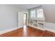 Bright bedroom featuring hardwood floors, an ensuite bathroom, and built-in shelving at 300 Mccauley St, Chapel Hill, NC 27516
