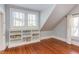 Cozy bedroom with hardwood floors, built-in shelving, and dual windows for ample light at 300 Mccauley St, Chapel Hill, NC 27516