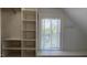 Walk-in closet with built-in shelving and a window for natural lighting at 300 Mccauley St, Chapel Hill, NC 27516