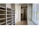 Walk-in closet with built-in shelving and racks for optimal storage at 300 Mccauley St, Chapel Hill, NC 27516