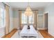 Bright dining room with hardwood floors, wainscoting, white table, and elegant chandelier at 300 Mccauley St, Chapel Hill, NC 27516