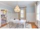 Light-filled dining room featuring hardwood floors, crystal chandelier and bright natural light at 300 Mccauley St, Chapel Hill, NC 27516