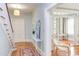 Inviting foyer with hardwood floors, staircase, console table, and view into adjacent living area at 300 Mccauley St, Chapel Hill, NC 27516