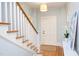 Bright foyer featuring hardwood floors, staircase, console table, and natural light at 300 Mccauley St, Chapel Hill, NC 27516