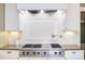 Close up of a kitchen featuring stainless steel appliances, a gas cooktop, granite countertops and custom cabinets at 300 Mccauley St, Chapel Hill, NC 27516