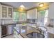 Bright, updated kitchen features granite countertops, stainless appliances, and breakfast bar at 300 Mccauley St, Chapel Hill, NC 27516