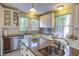 A beautifully appointed kitchen features custom cabinets, granite counters, and modern stainless appliances at 300 Mccauley St, Chapel Hill, NC 27516