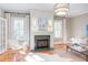Living room featuring fireplace, hardwood floors, neutral colors and light-filled windows at 300 Mccauley St, Chapel Hill, NC 27516