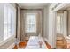 Well-lit home office featuring hardwood floors, neutral walls, bright windows, and stylish curtains with geometric patterns at 300 Mccauley St, Chapel Hill, NC 27516
