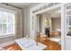 Bright home office with hardwood floors, neutral walls, and large windows with blinds and curtains that provide ample natural light at 300 Mccauley St, Chapel Hill, NC 27516