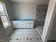 Bathroom features a new window, gray tile floors, a white vanity and a tiled shower at 307 Chesapeake Commons St # 100, Garner, NC 27529