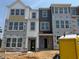 New construction of modern two-story townhomes, with multiple windows and contemporary design elements at 307 Chesapeake Commons St # 100, Garner, NC 27529