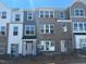 New townhome exteriors displaying a mix of brick and siding at 307 Chesapeake Commons St # 100, Garner, NC 27529