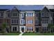 Charming three-story townhome with brick and siding, and well-manicured landscaping, inviting curb appeal at 307 Chesapeake Commons St # 100, Garner, NC 27529