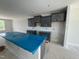Kitchen featuring gray cabinets, light-gray subway tile backsplash and a large, covered island at 307 Chesapeake Commons St # 100, Garner, NC 27529