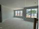 Living room with large windows overlooking the lawn; new construction, light gray paint, new windows at 307 Chesapeake Commons St # 100, Garner, NC 27529