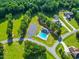 Aerial view of community pool, clubhouse, parking, and lush greenery, offering a serene and convenient lifestyle at 309 Shoreline Dr, Princeton, NC 27569