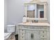 Classic bathroom with ornate vanity, tile floors, toilet, and a framed mirror providing a refined look at 309 Shoreline Dr, Princeton, NC 27569